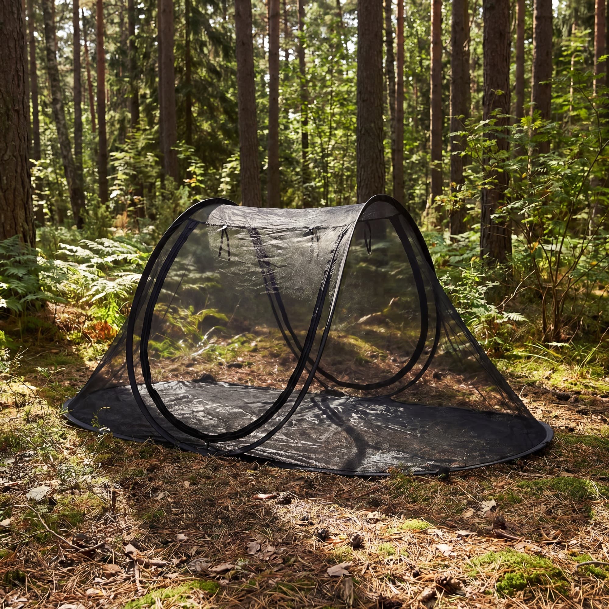 The white Mosticare Igloo, a freestanding pop-up mosquito tent, pitched by a lake at sunset.